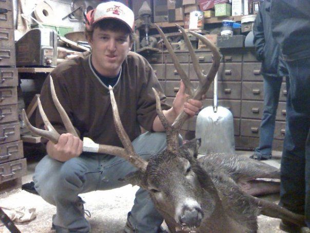 me and deer in shed before hangin him up