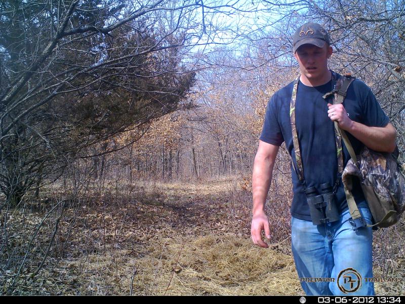 Trail camera picture with shed on the ground. By my arm.